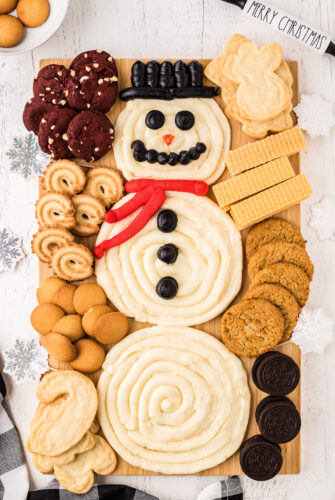 Snowman buttercream board with assorted cookies for dipping.