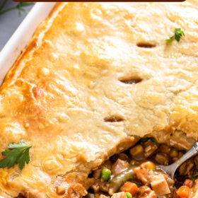 Turkey pot pie with a spoon scooping out a serving.