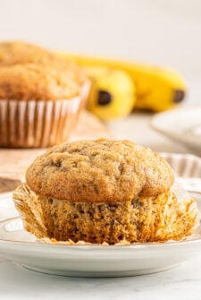 A banana muffin with the muffin liner pulled away from the base.