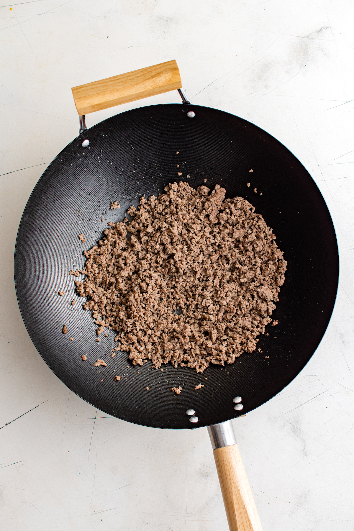 Ground beef cooking in a wok.