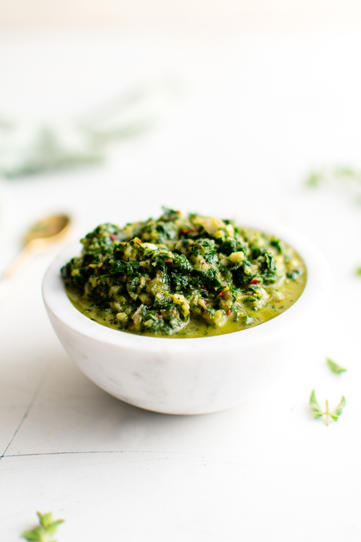 Chimichurri sauce in a white bowl.