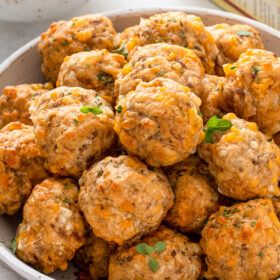 A bowl of sausage balls stacked on top of each other.