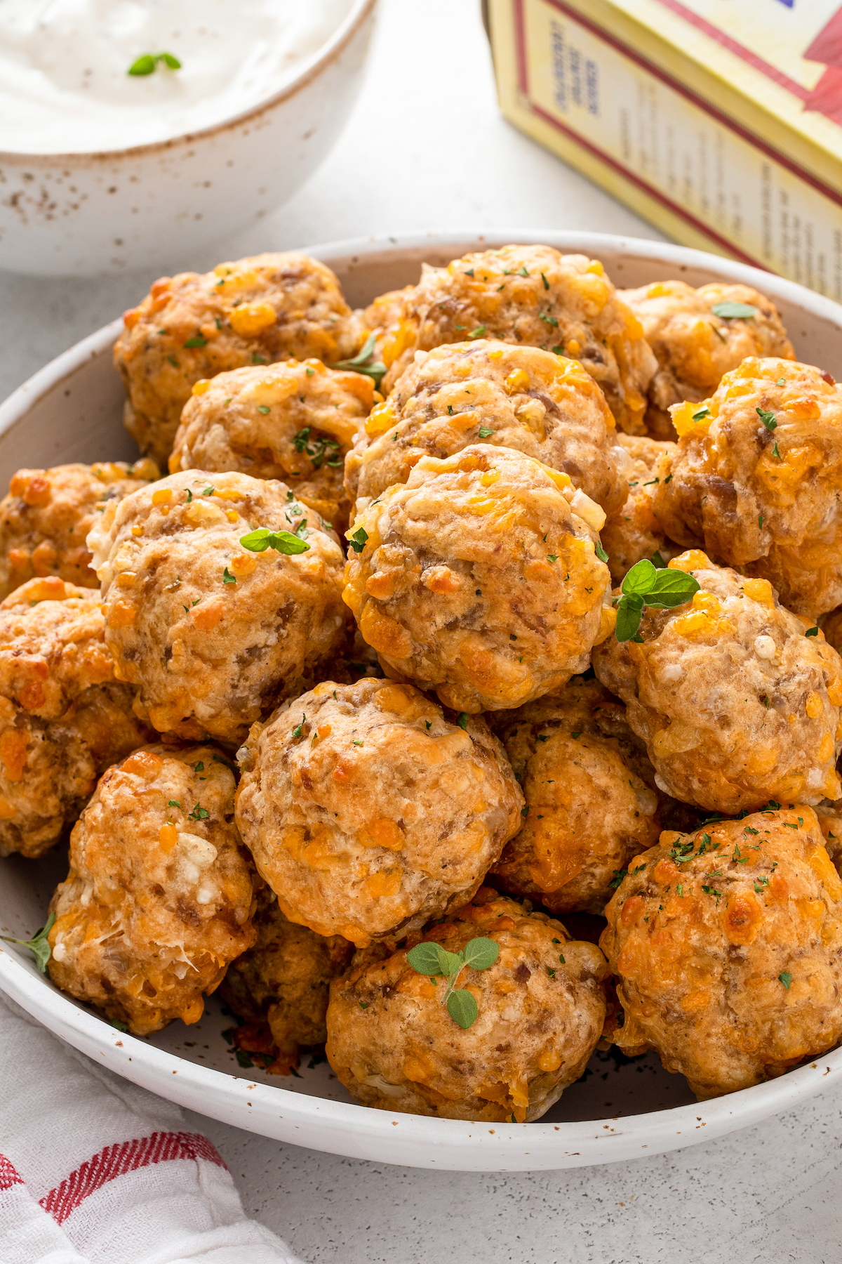A bowl of sausage balls stacked on top of each other.