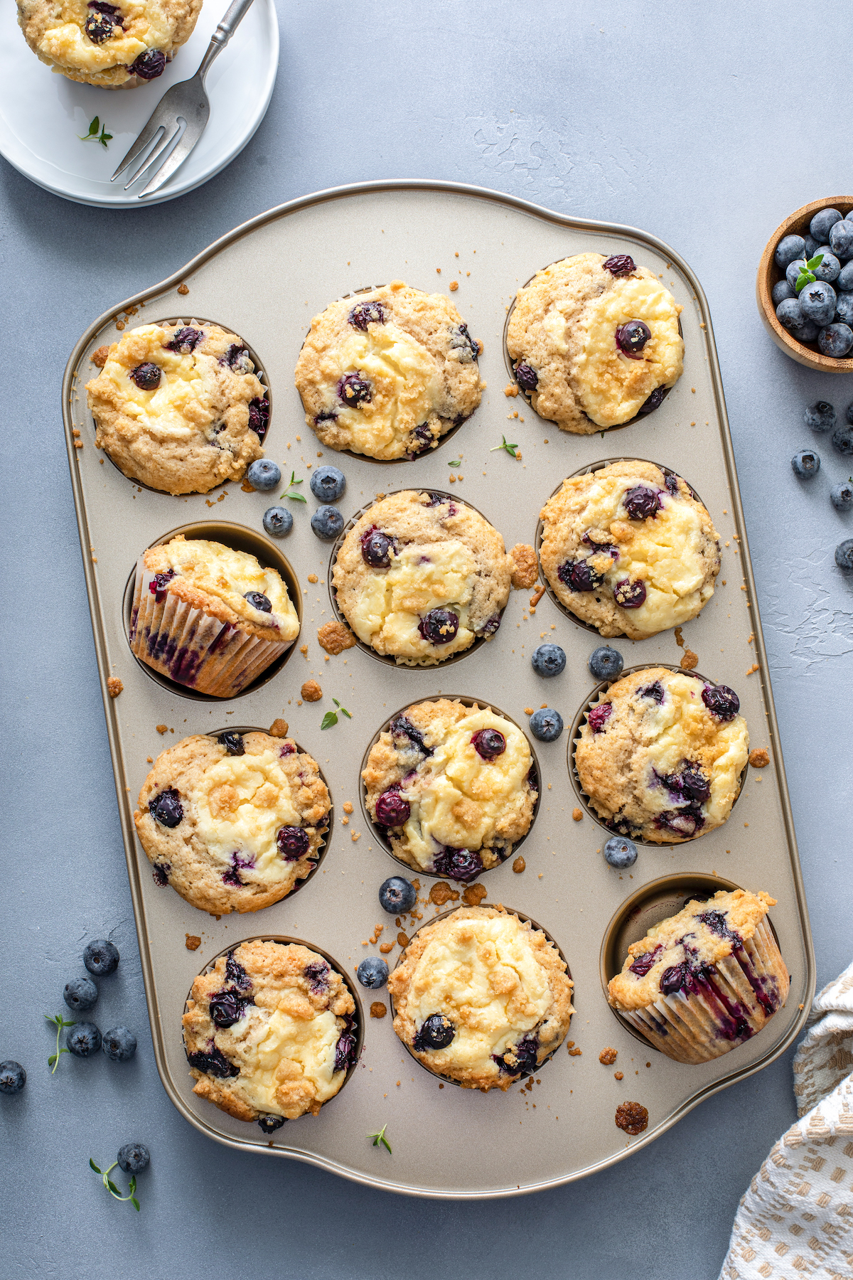 Baked blueberry muffins with cream cheese and streusel.