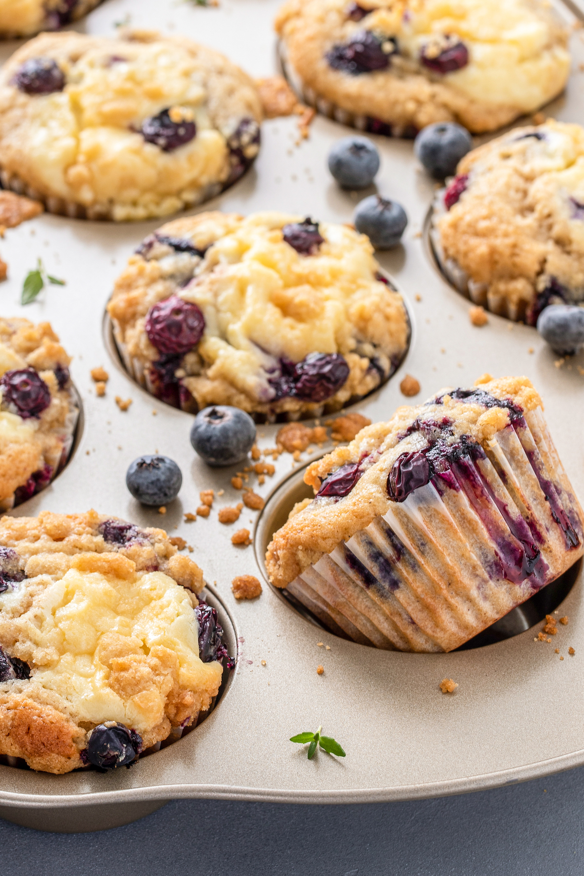 Blueberry cream cheese muffins in a muffin tin.
