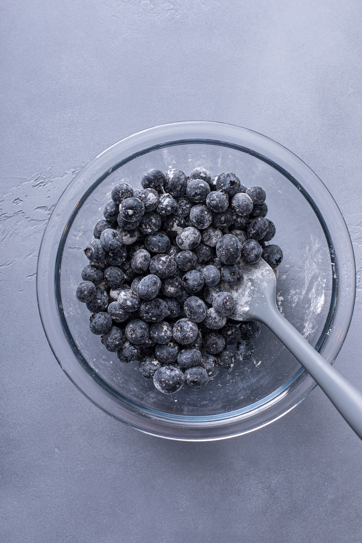 Coating blueberries with flour.