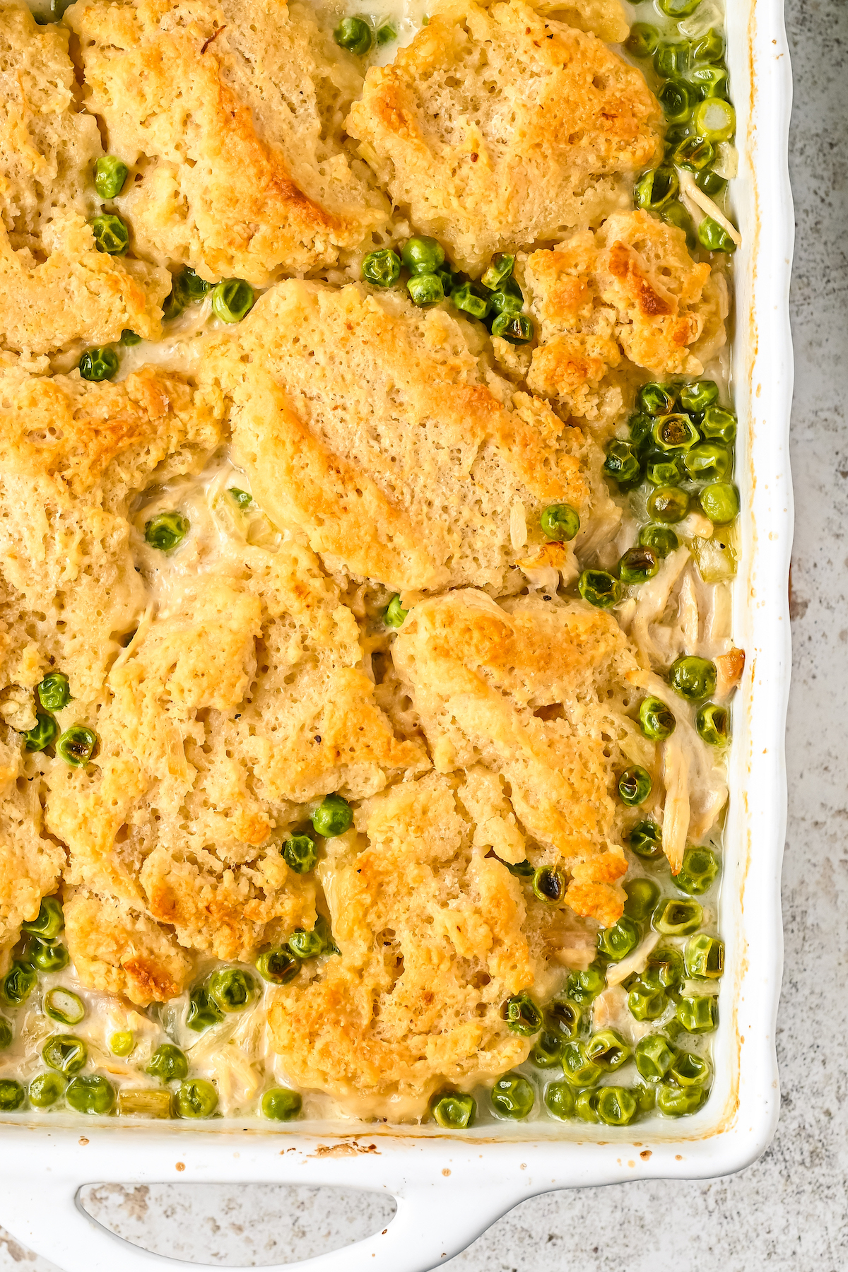 Oven-baked chicken and dumplings in a white casserole dish.