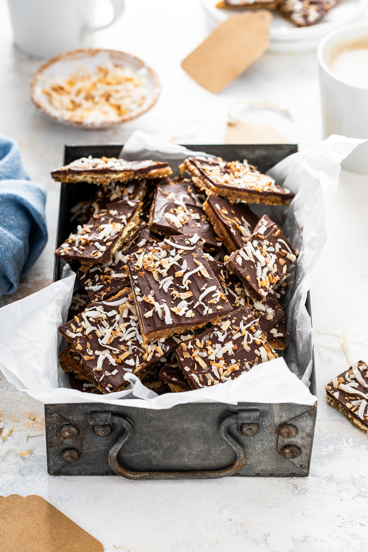 A metal tray filled with saltine cracker toffee.