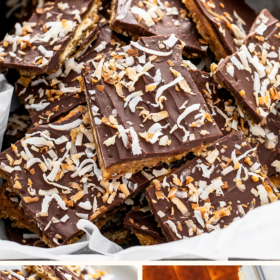 A tray of coconut saltine cracker toffee and toffee poured over saltine crackers on a cookie sheet.
