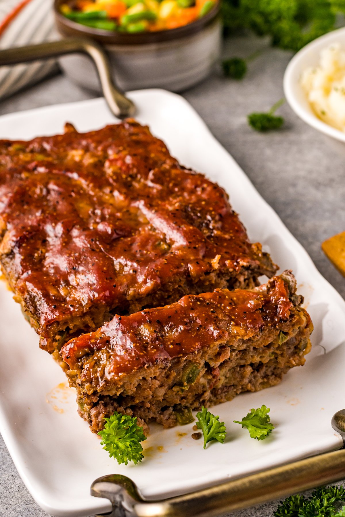A cooked ground beef loaf on a rectangular platter.