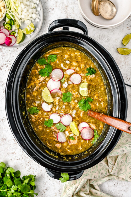 Mexican pozole with toppings in the crockpot.