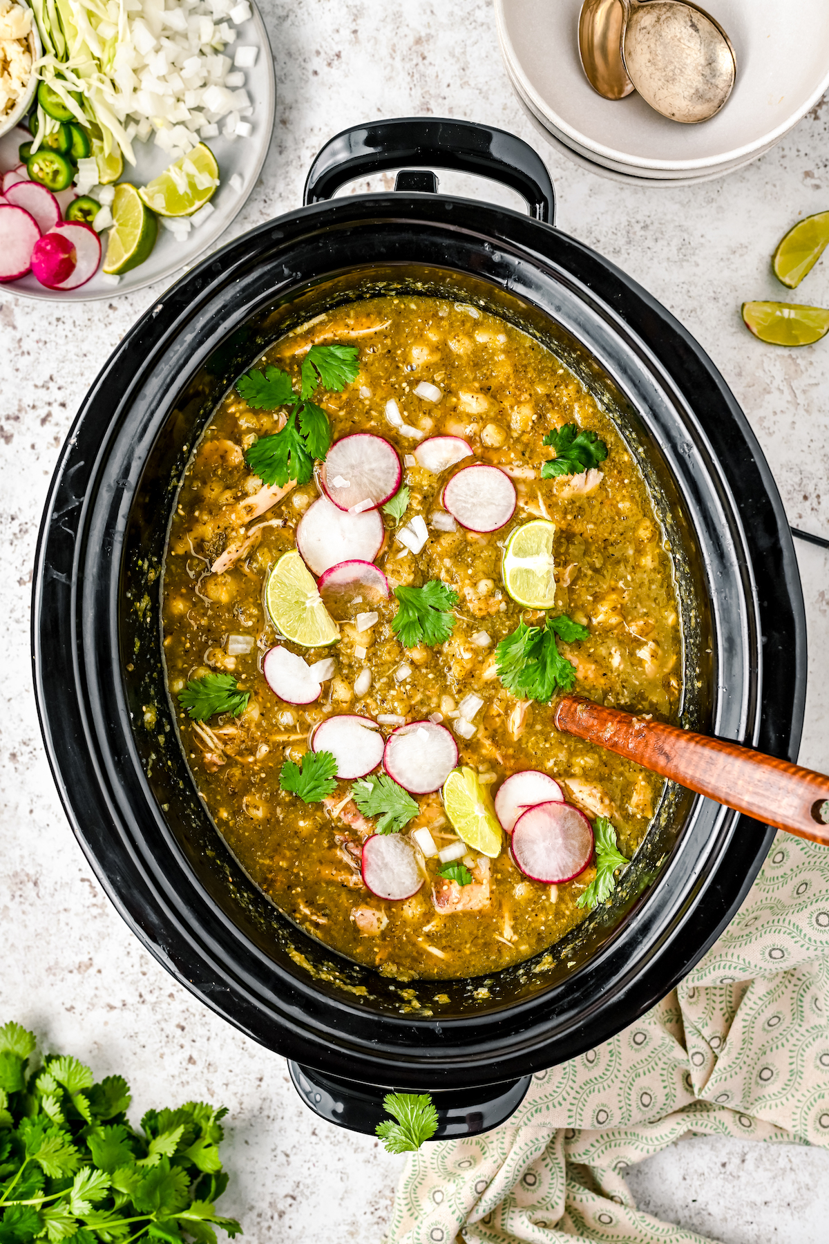 Mexican pozole with toppings in the crockpot.