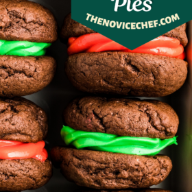 Red and green chocolate whoopie pies stacked in a tray.