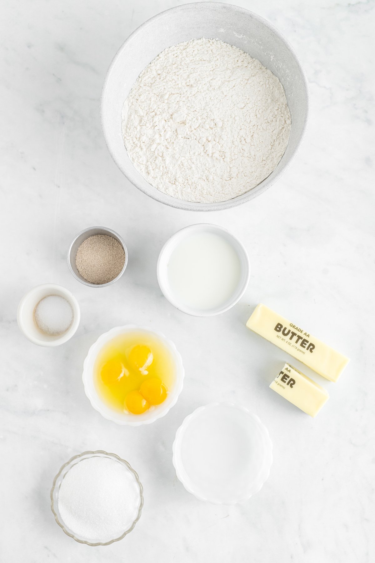 From top: Flour, milk, butter, water, sugar, eggs, yeast, salt.