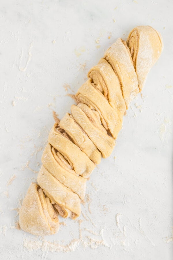 A log of dough cut on the bias into slices.