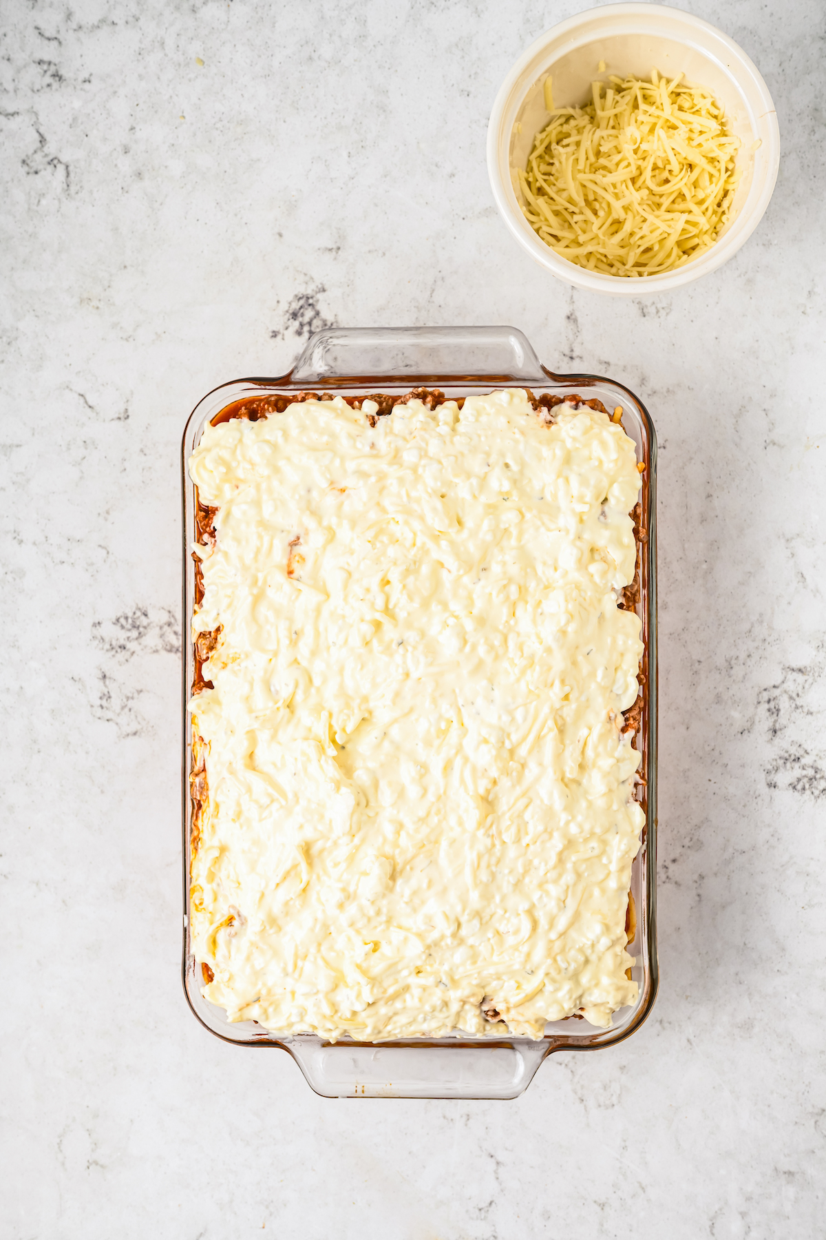 A casserole topped with a cheese mixture.