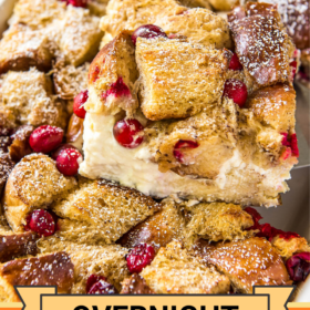 A slice of cranberry French toast casserole being lifted out of a casserole dish.