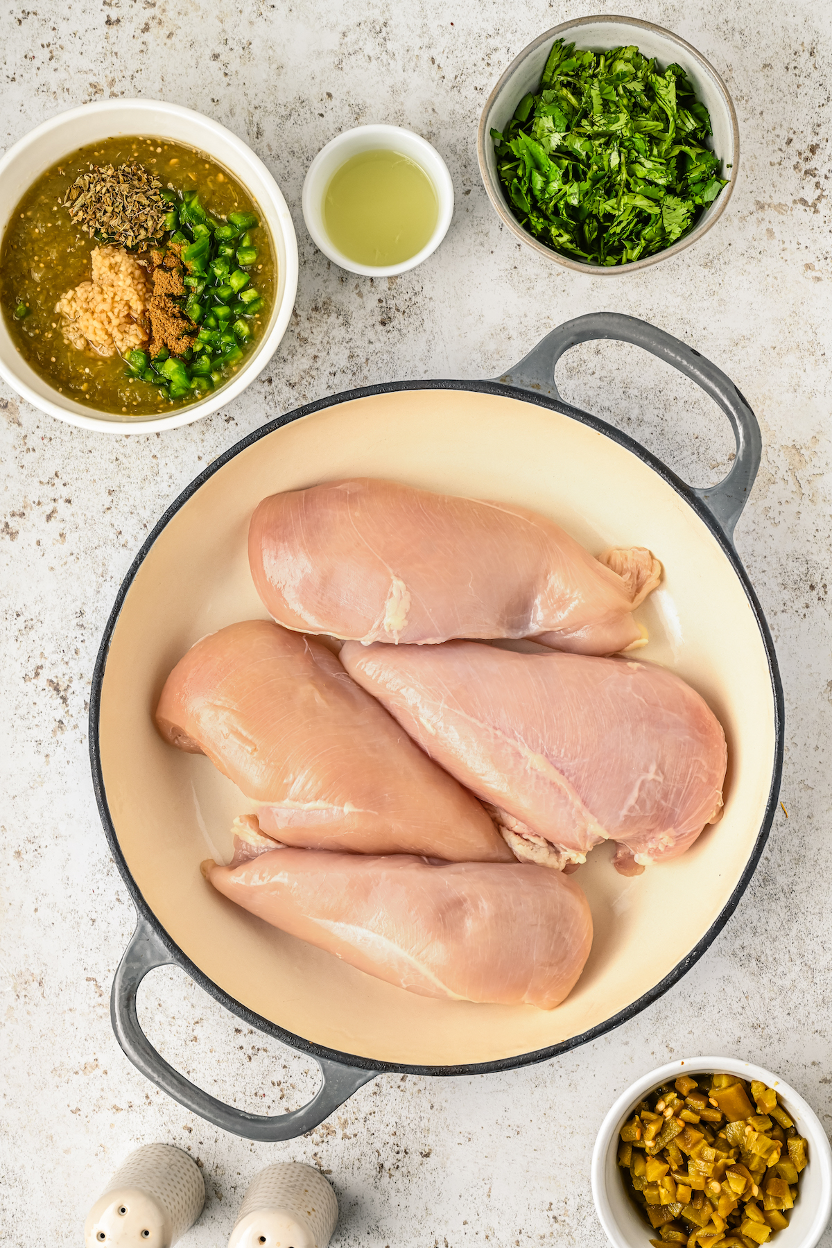 Placing the chicken breasts in the greased baking dish.