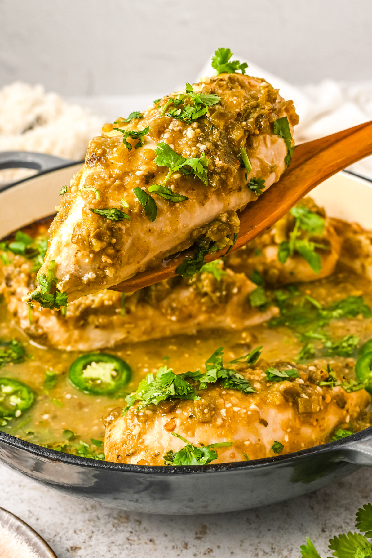 Salsa verde chicken on a spatula.