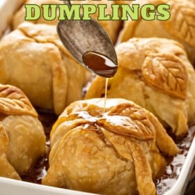 Old fashioned apple dumplings in a casserole dish with sauce.