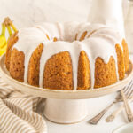 A banana bundt cake on a cake stand.
