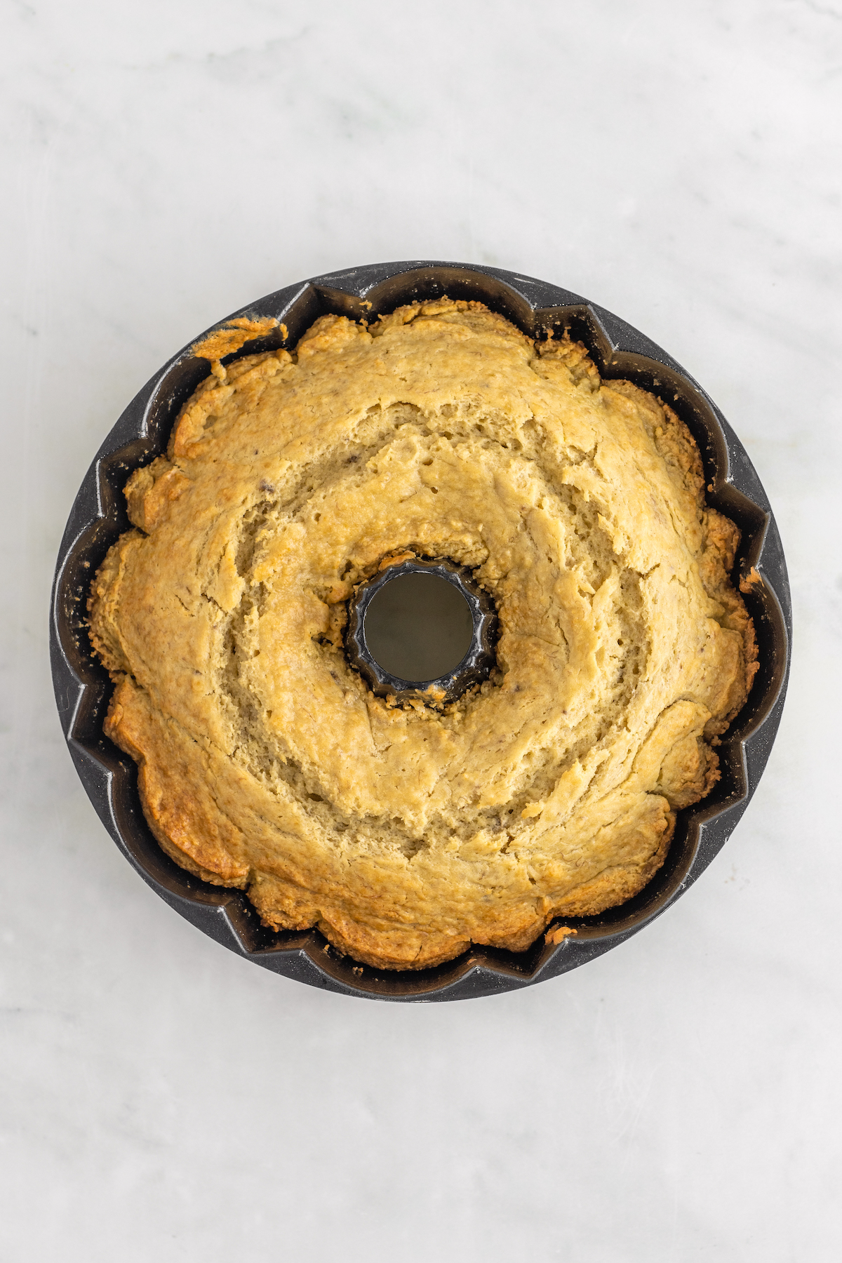 A baked banana bundt cake in the pan.