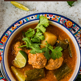 A bowl of mexican meatball soup with cilantro on top.