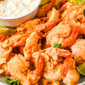 Close-up of Mexican fried shrimp with creamy dipping sauce.