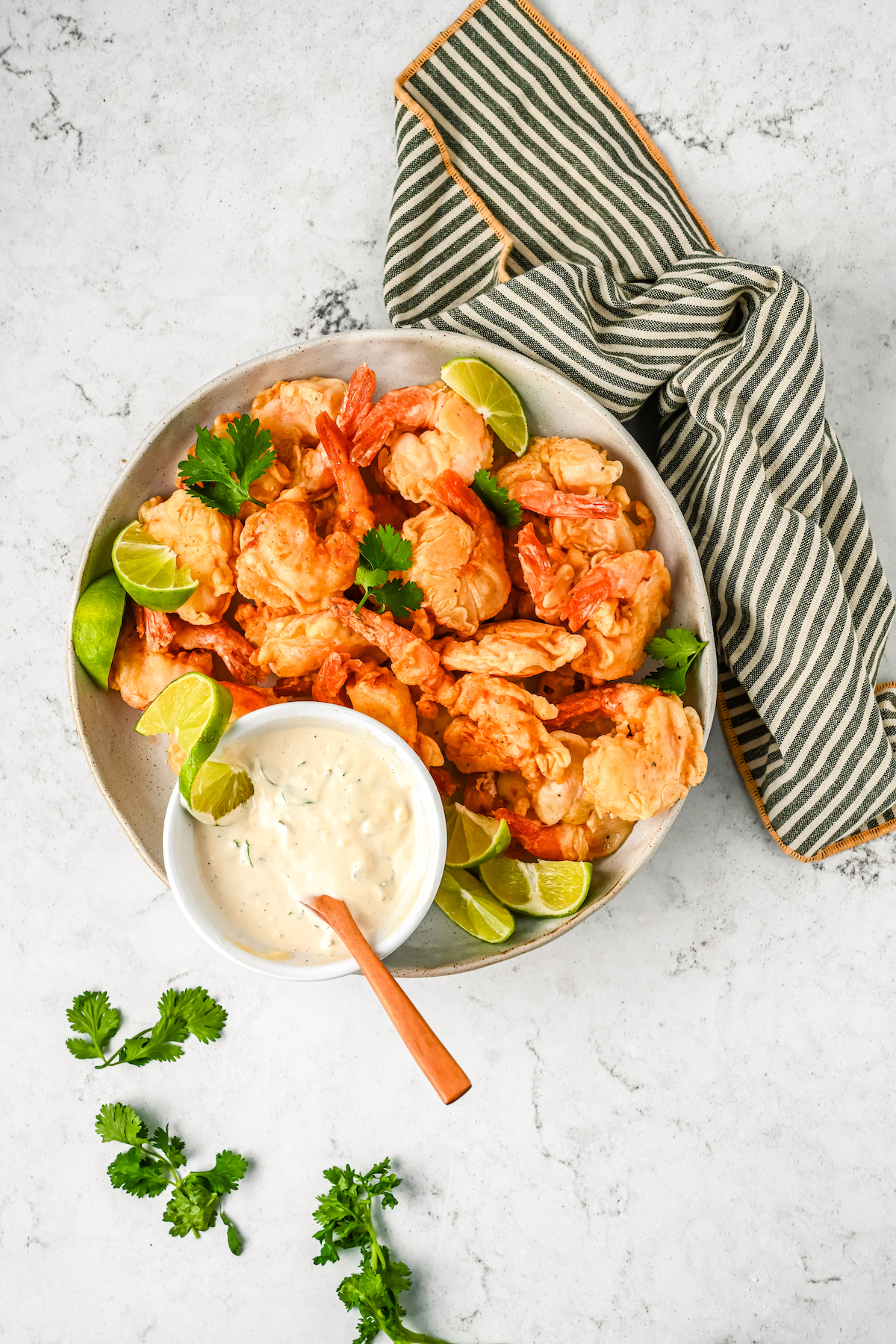 Mexican fried shrimp with creamy dipping sauce on the side.