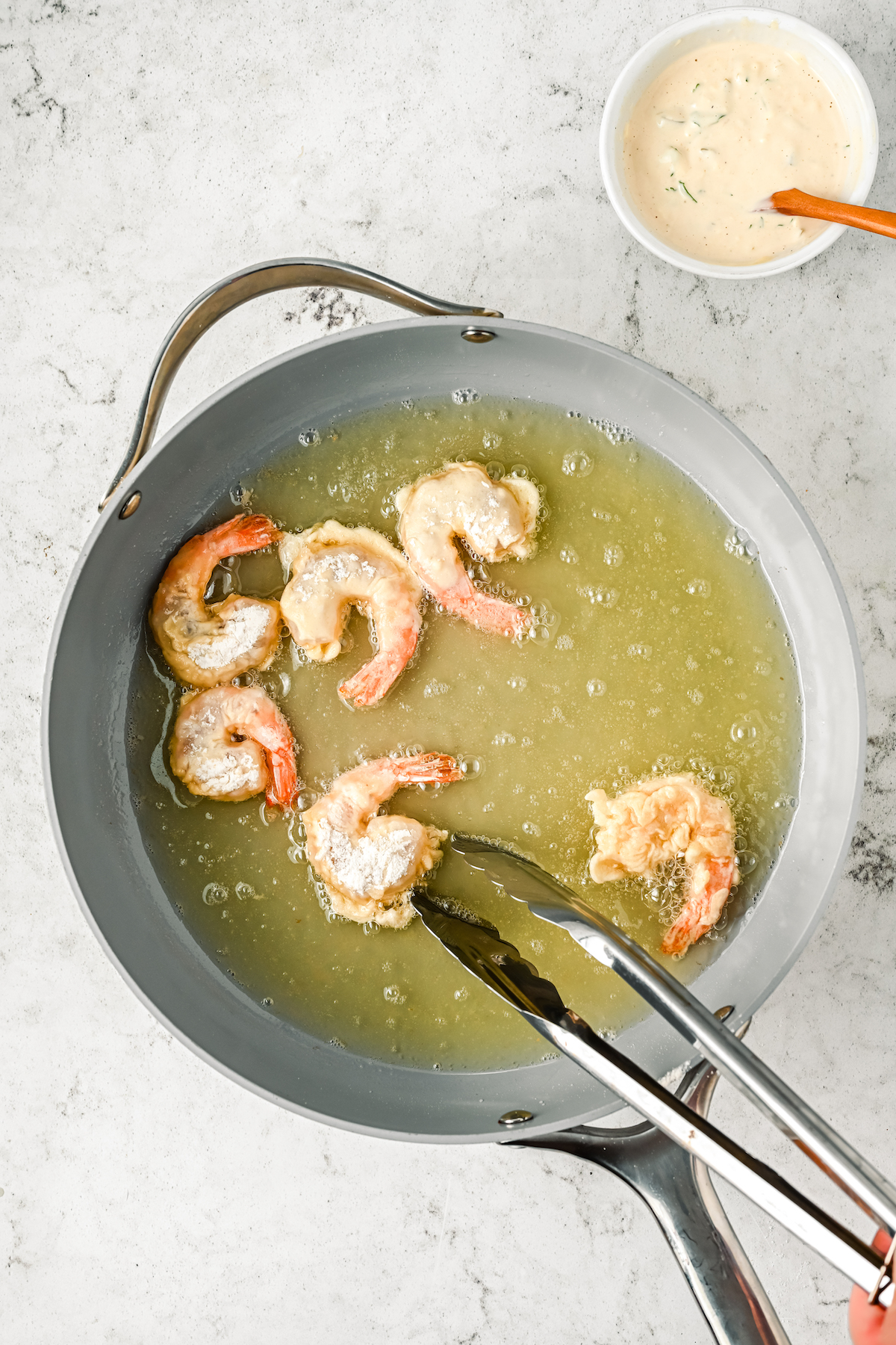 Frying the shrimp in oil.