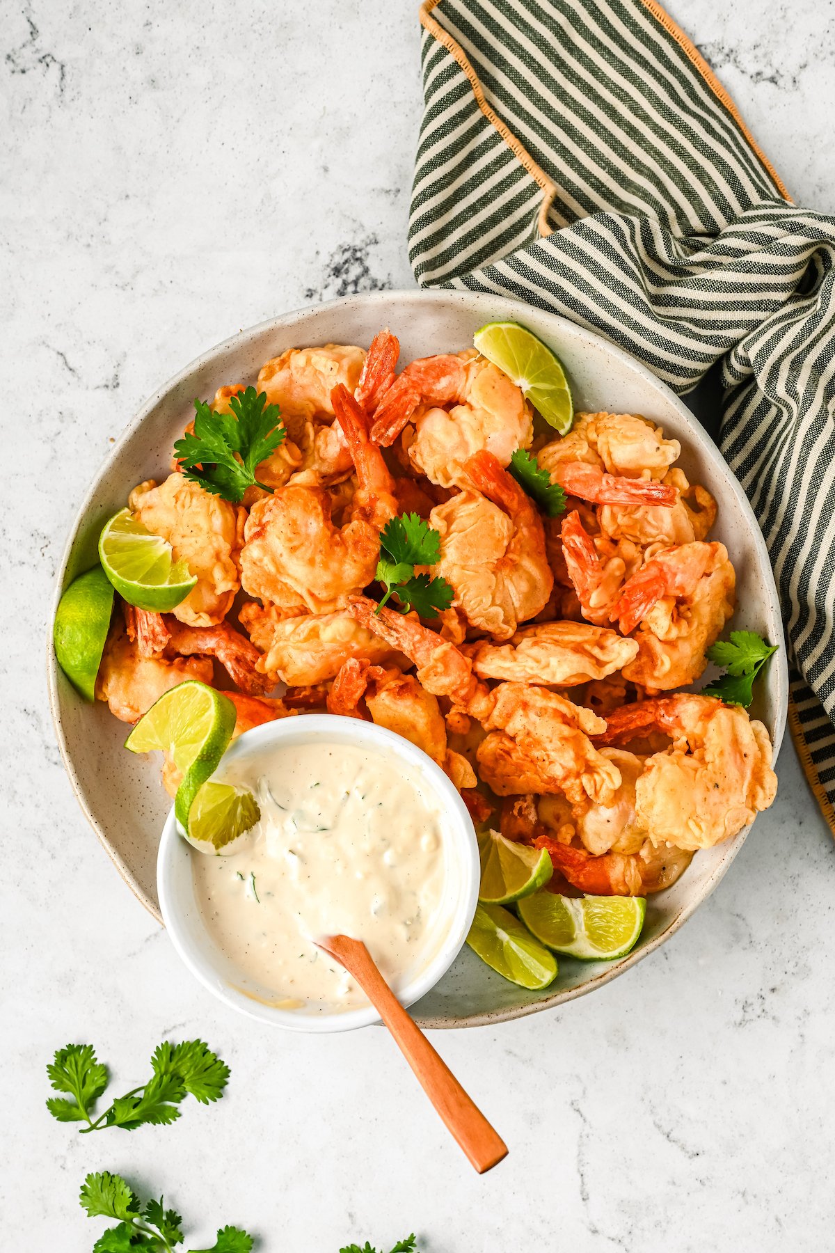 Mexican fried shrimp with dipping sauce on the side.