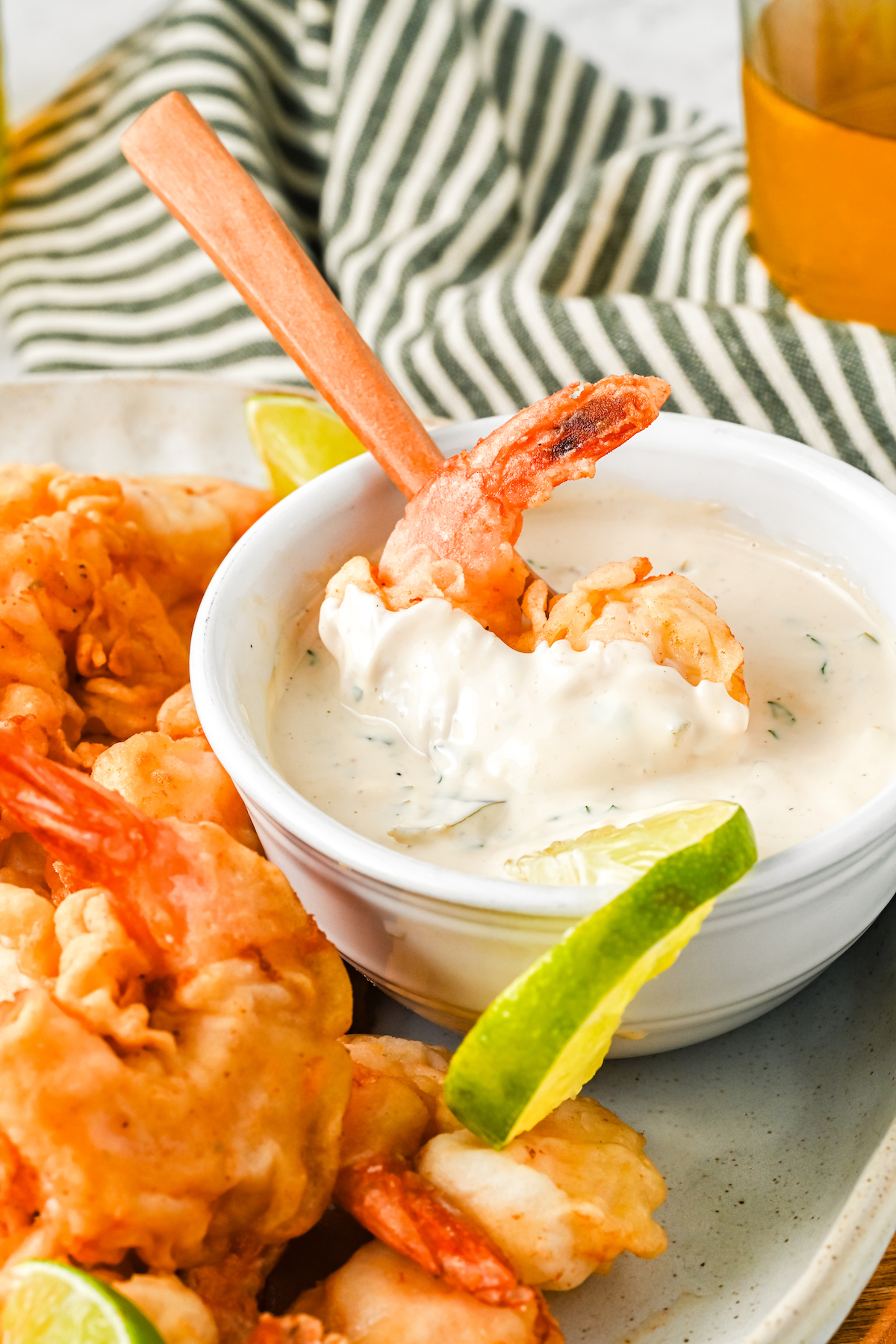 Dipping a Mexican fried shrimp in dipping sauce.