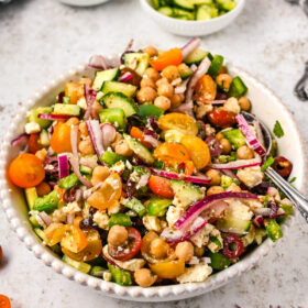 Chickpea salad with vegetables in a white bowl.
