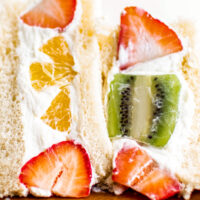Four sando halves lined up to show the texture of the fruit and whipped cream filling.