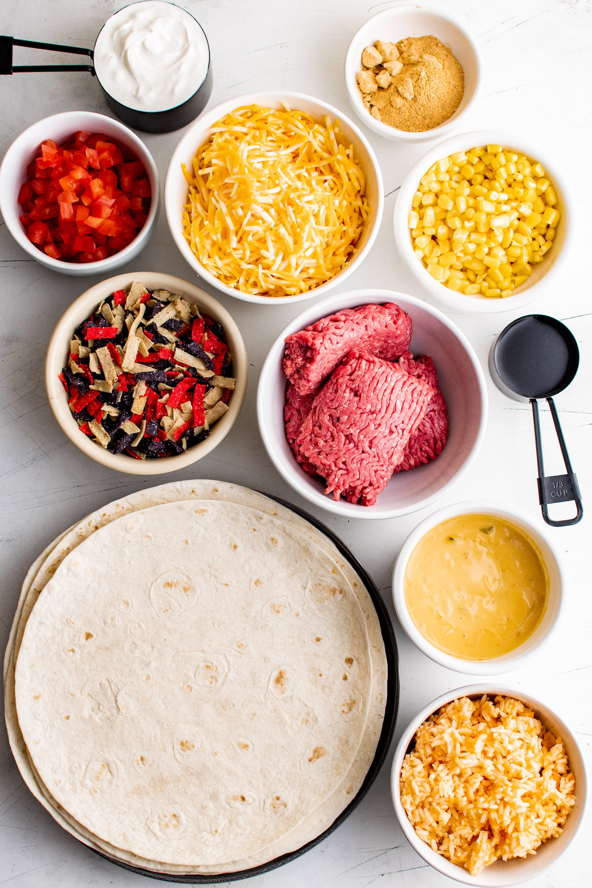 Burrito ingredients measured and arranged on a work surface.