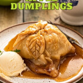 Apple dumpling on a plate with ice cream and sauce.