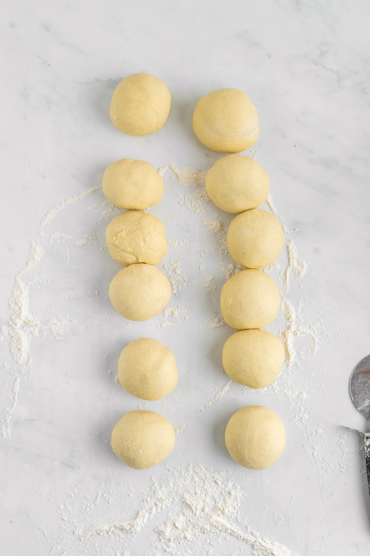 Balls of dough on a floured work surface.