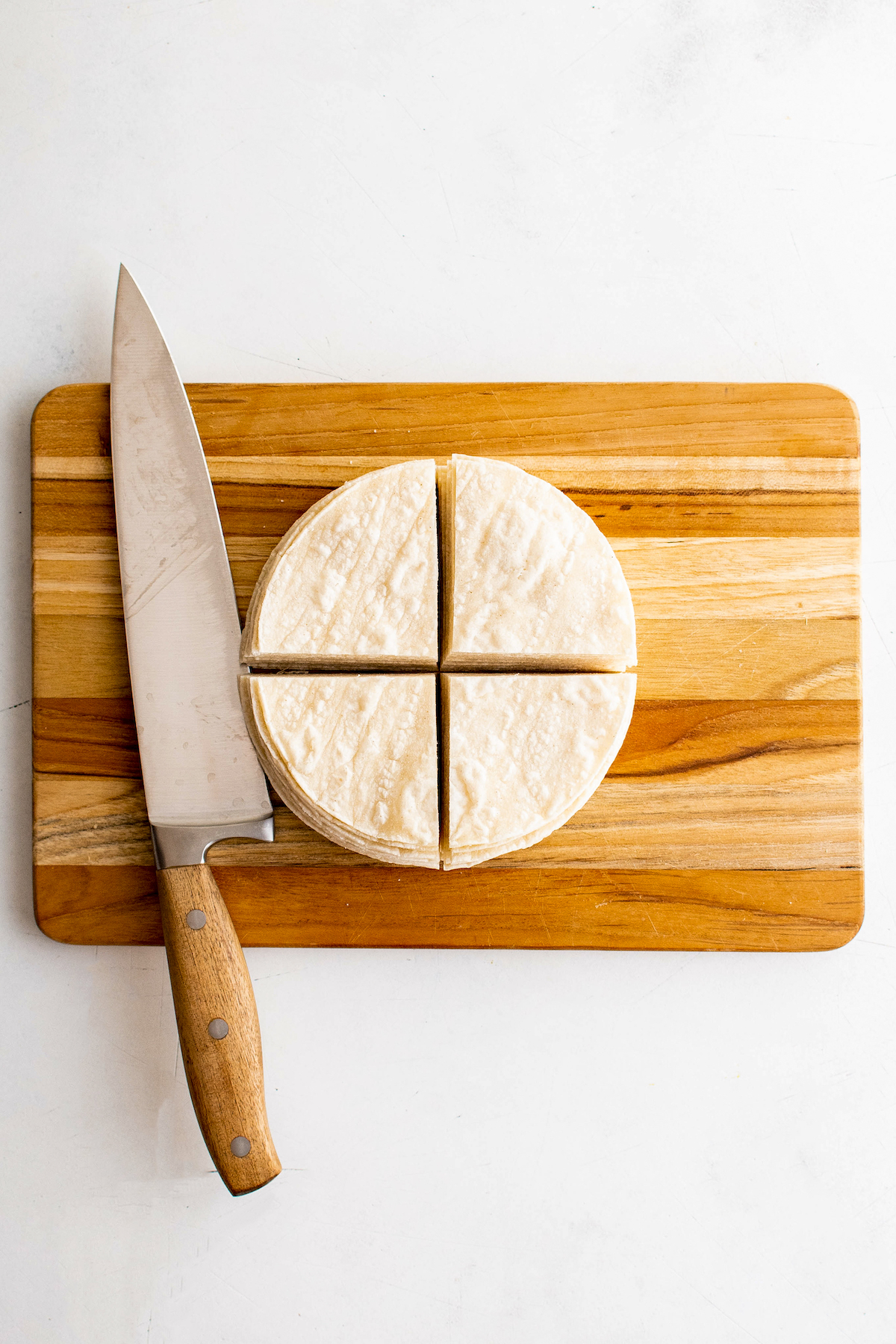 Slicing the tortillas in quarter.