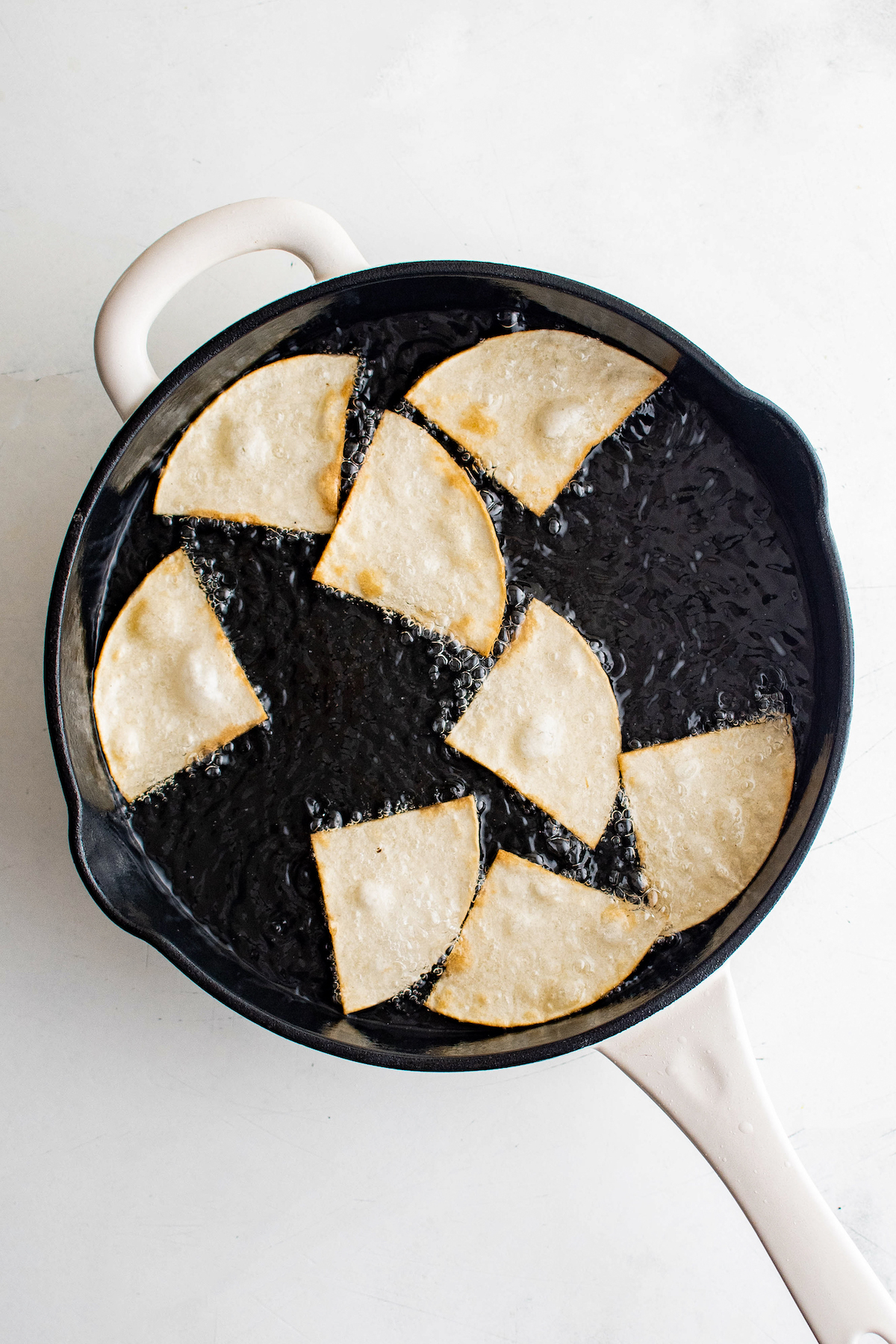 Frying the tortilla triangles.