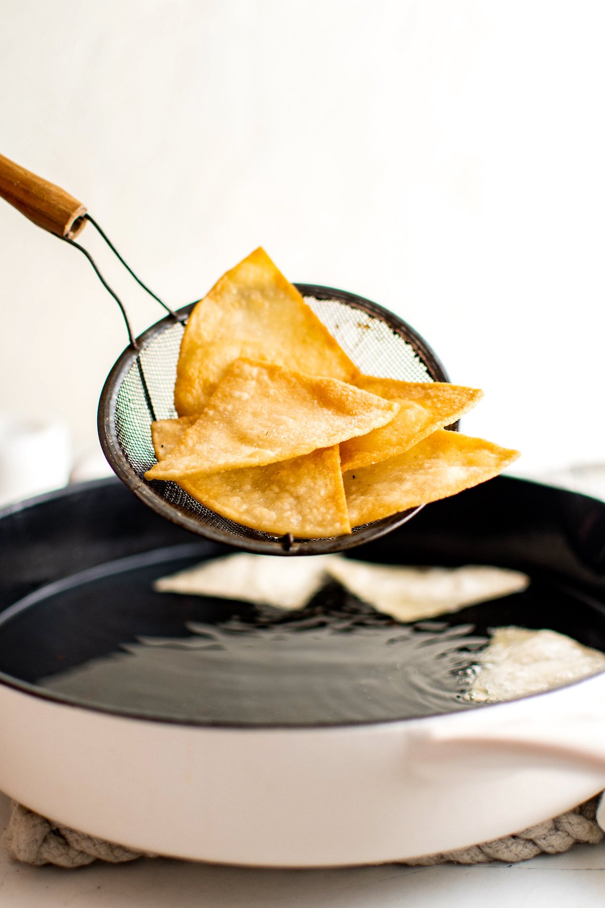 Removing the tortilla chips from the  pot.
