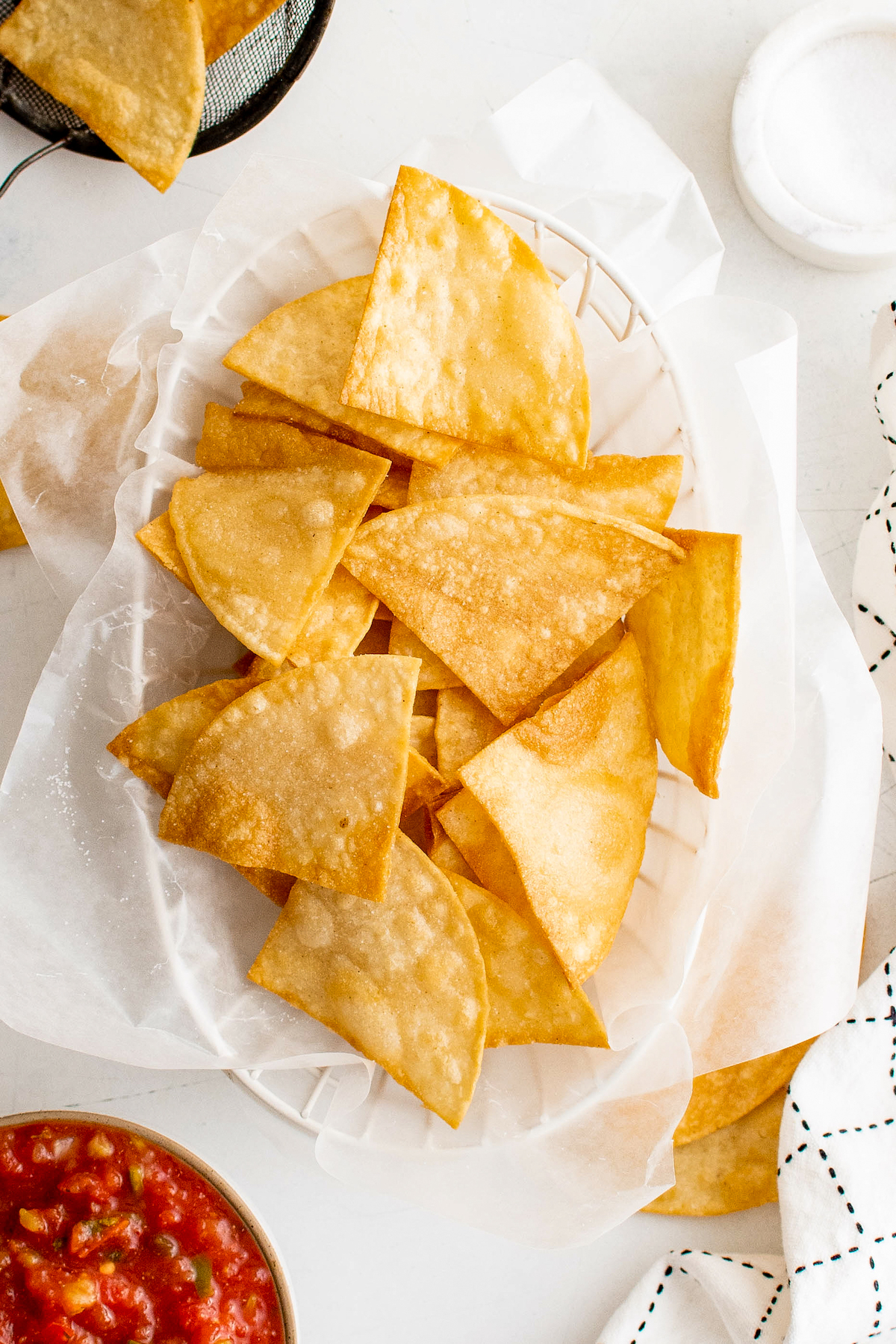 Paper towel lined basket with corn tortilla chips.