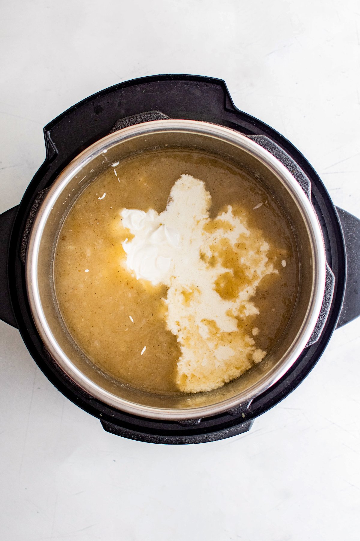 Cream poured into soup an electric pressure cooker.