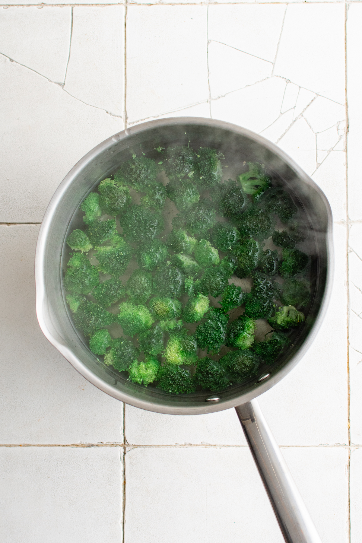 Broccoli boiling in a pot for a baked potato recipe.