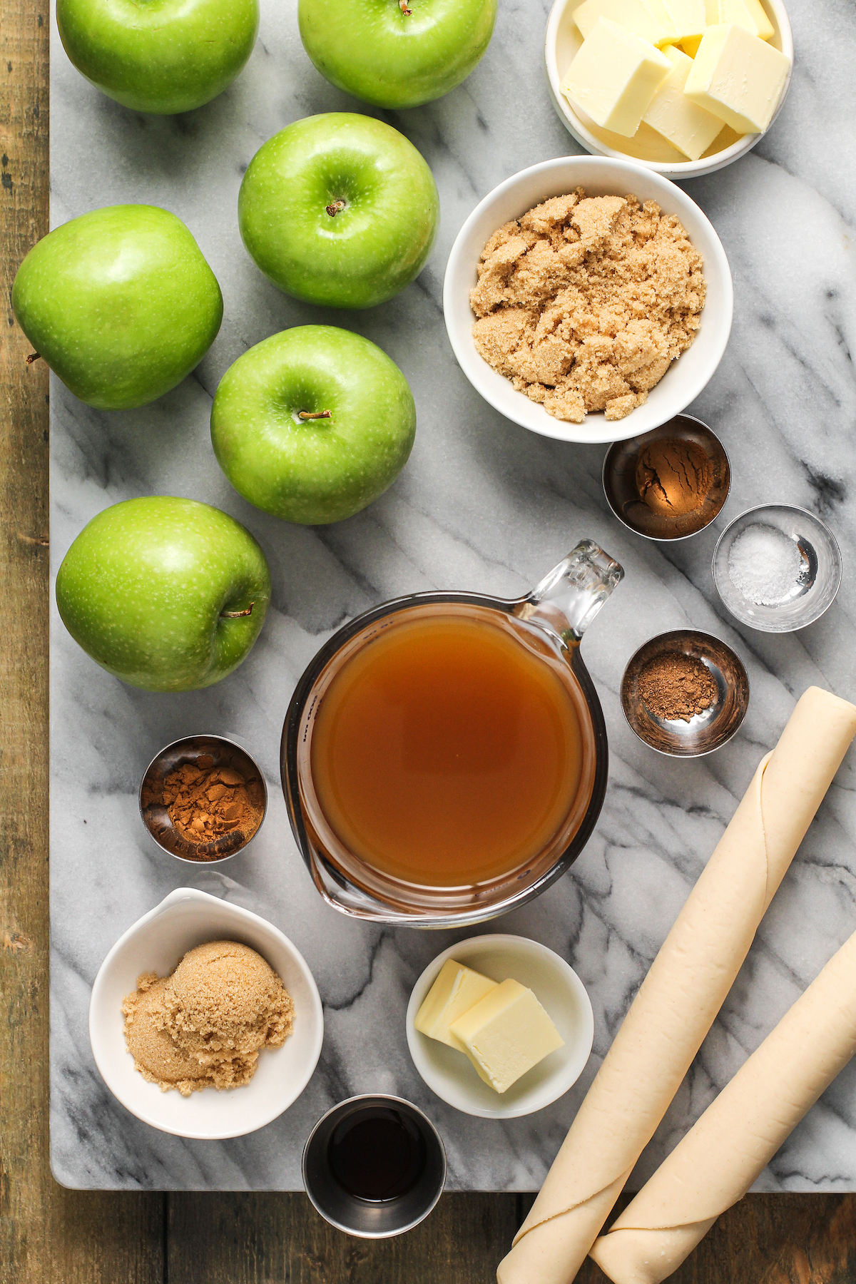 Apple dumpling ingredients measured and arranged on a marble cutting board.