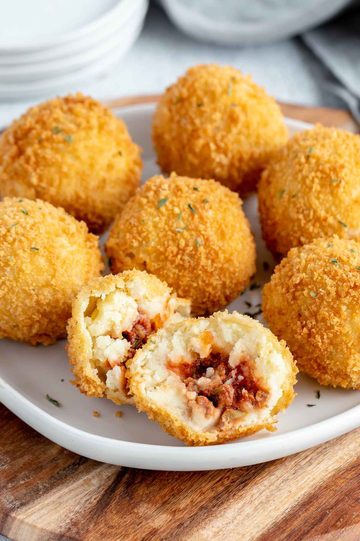 Fried potatoes stuffed with picadillo filling on a plate.