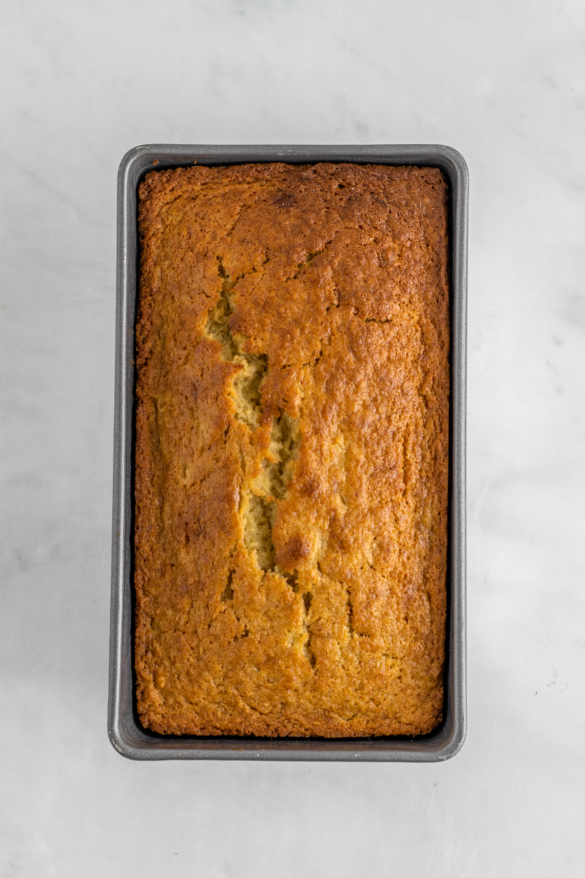 A baked quick bread loaf in a pan.
