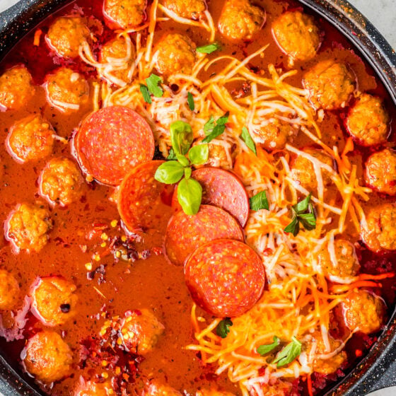 Overhead shot of pizza soup with meatballs.