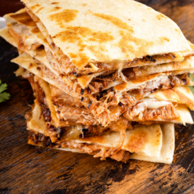 Pulled pork quesadillas stacked on top of each other.