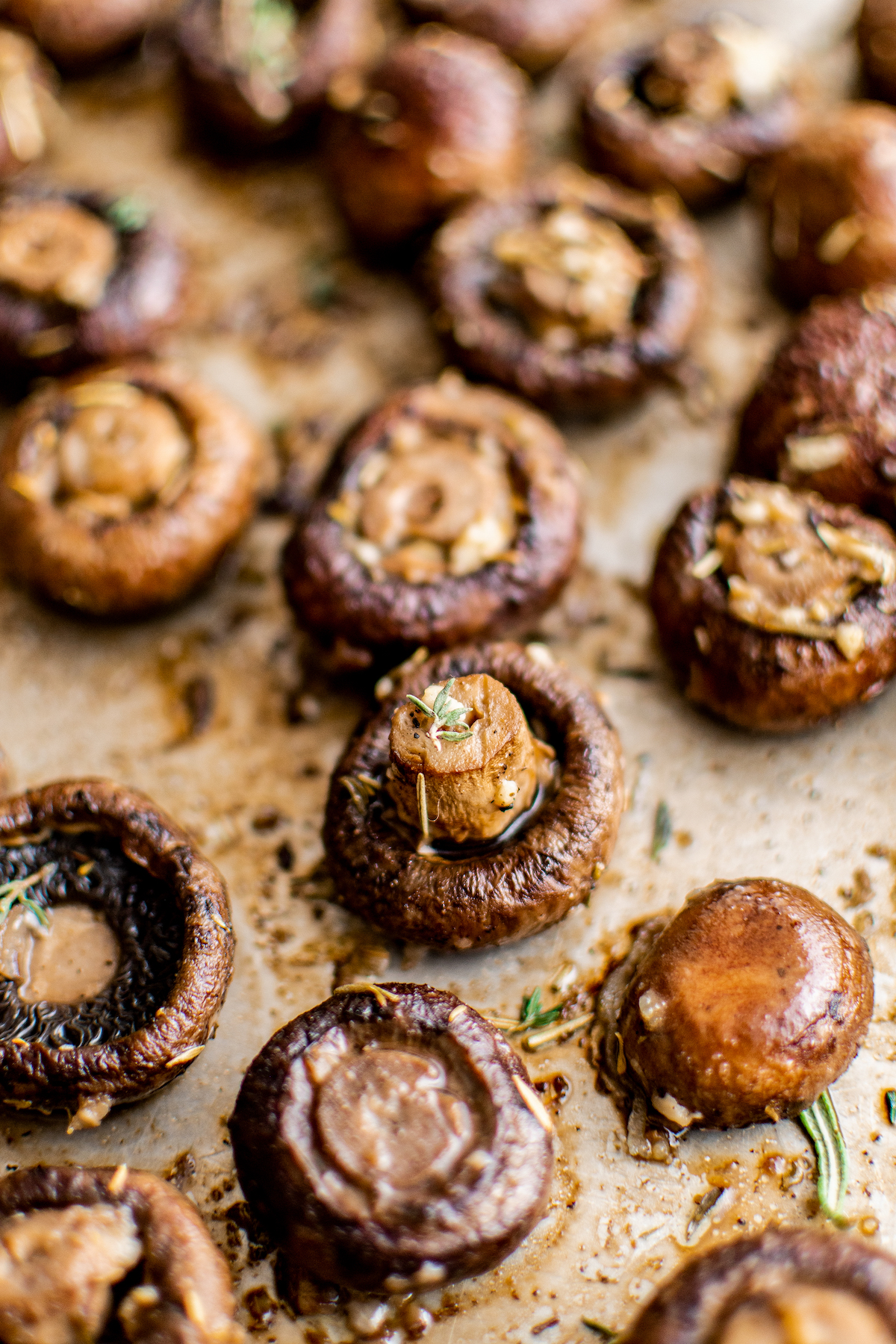 Close-up shot of roasted mushrooms on a sheet pan.
