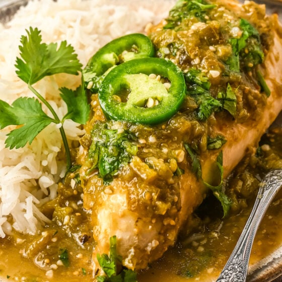 A plate of salsa verde chicken on a plate with a fork.